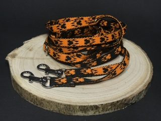 Palkar vodítko prepínacie z popruhu pre psov 250 cm x 10 mm čierno-oranžová s labkami