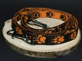 Palkar vodítko prepínacie z popruhu pre psov 250 cm x 20 mm čierno-oranžová s labkami